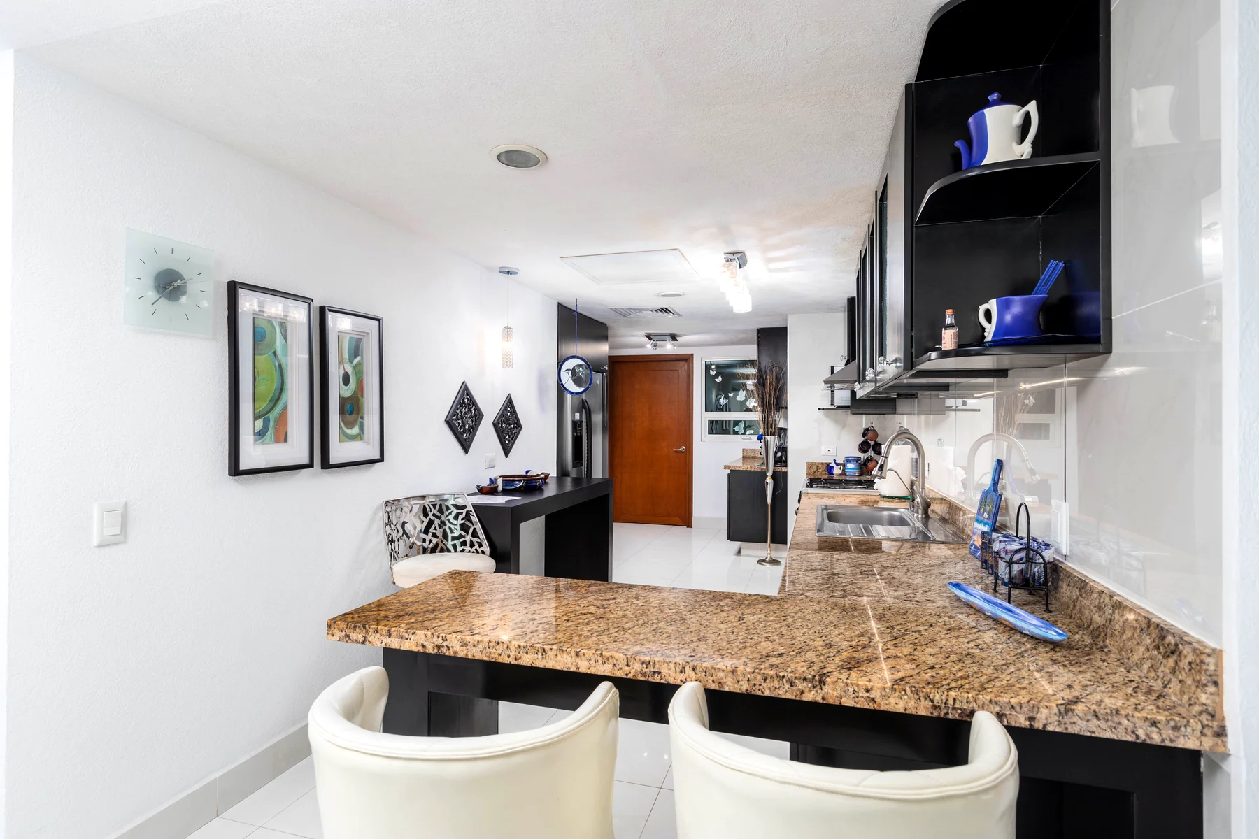 Stools beside the granite kitchen bar