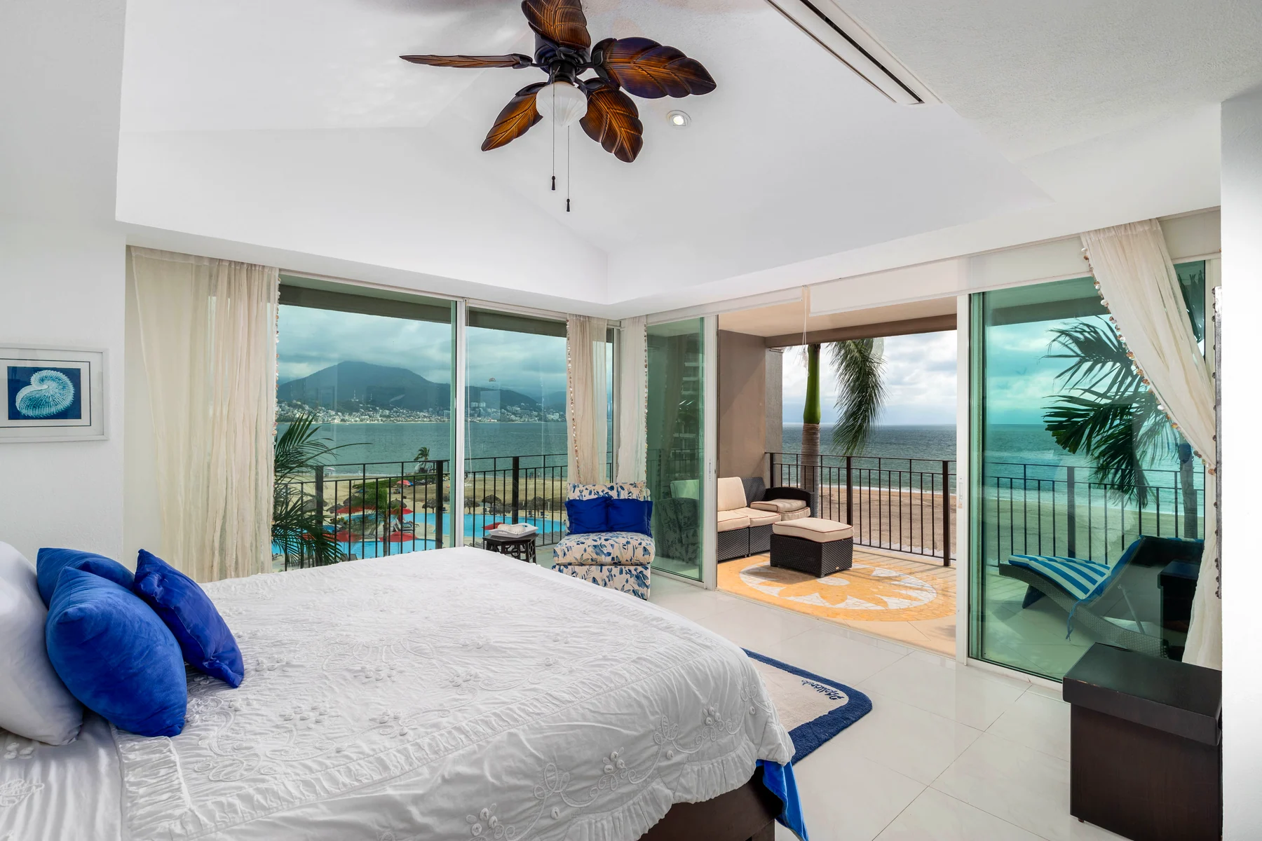 Primary bedroom opening straight onto the terrace with a sea view