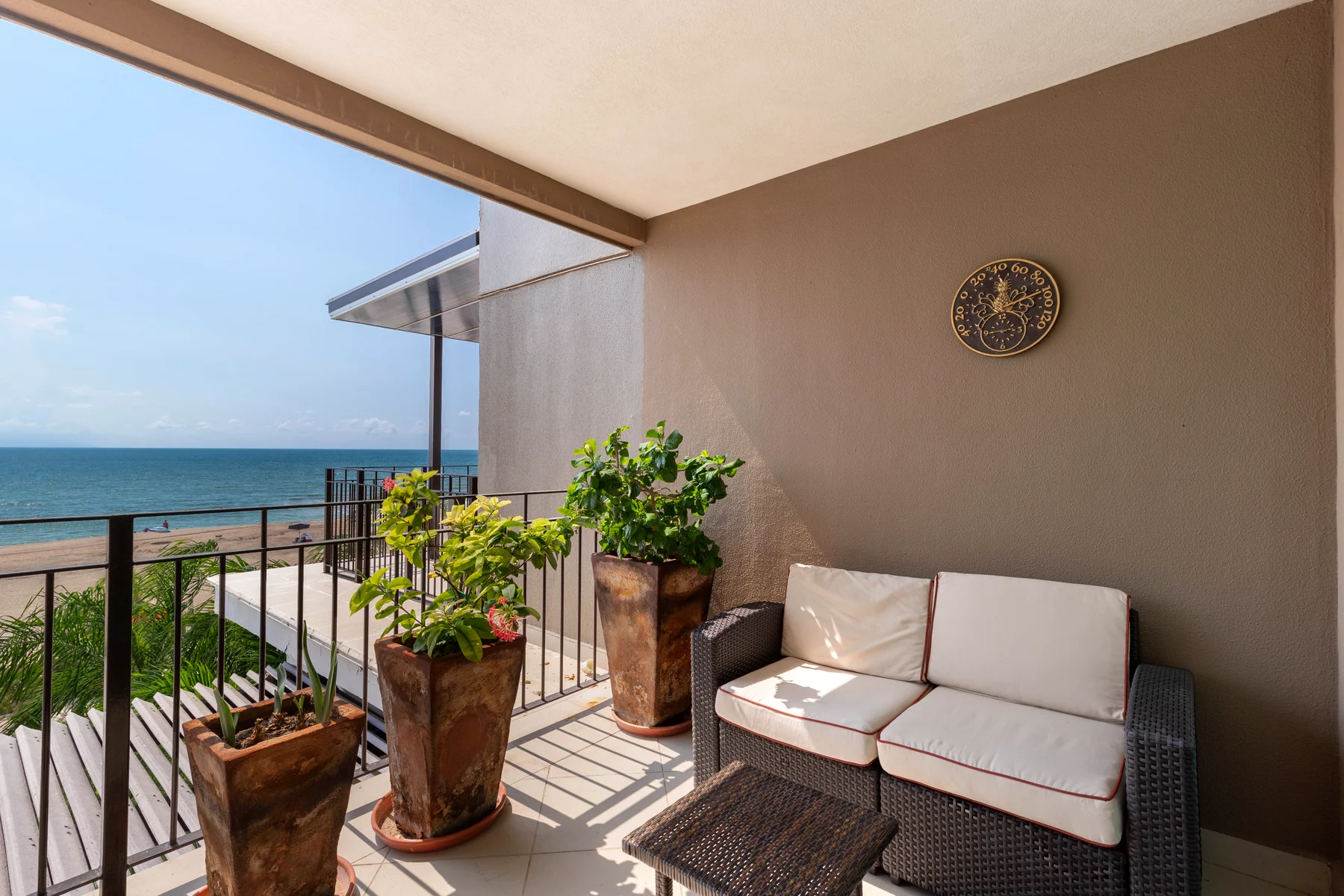 A corner of the terrace with outdoor seating and planters